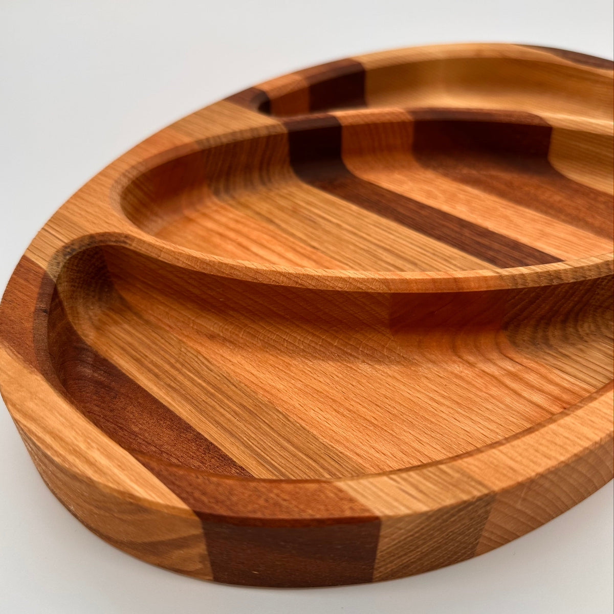 Wooden tray with a striped pattern on a white background