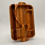 Wooden tray with geometric compartments on a light gray background