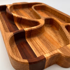 Wooden tray with divided sections on a white background