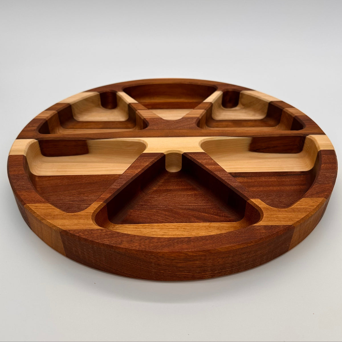 Wooden tray with divided sections on a white background