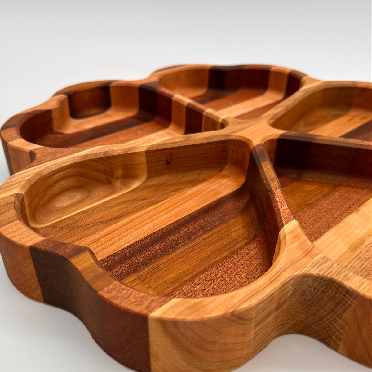 Wooden tray with compartments on a white background