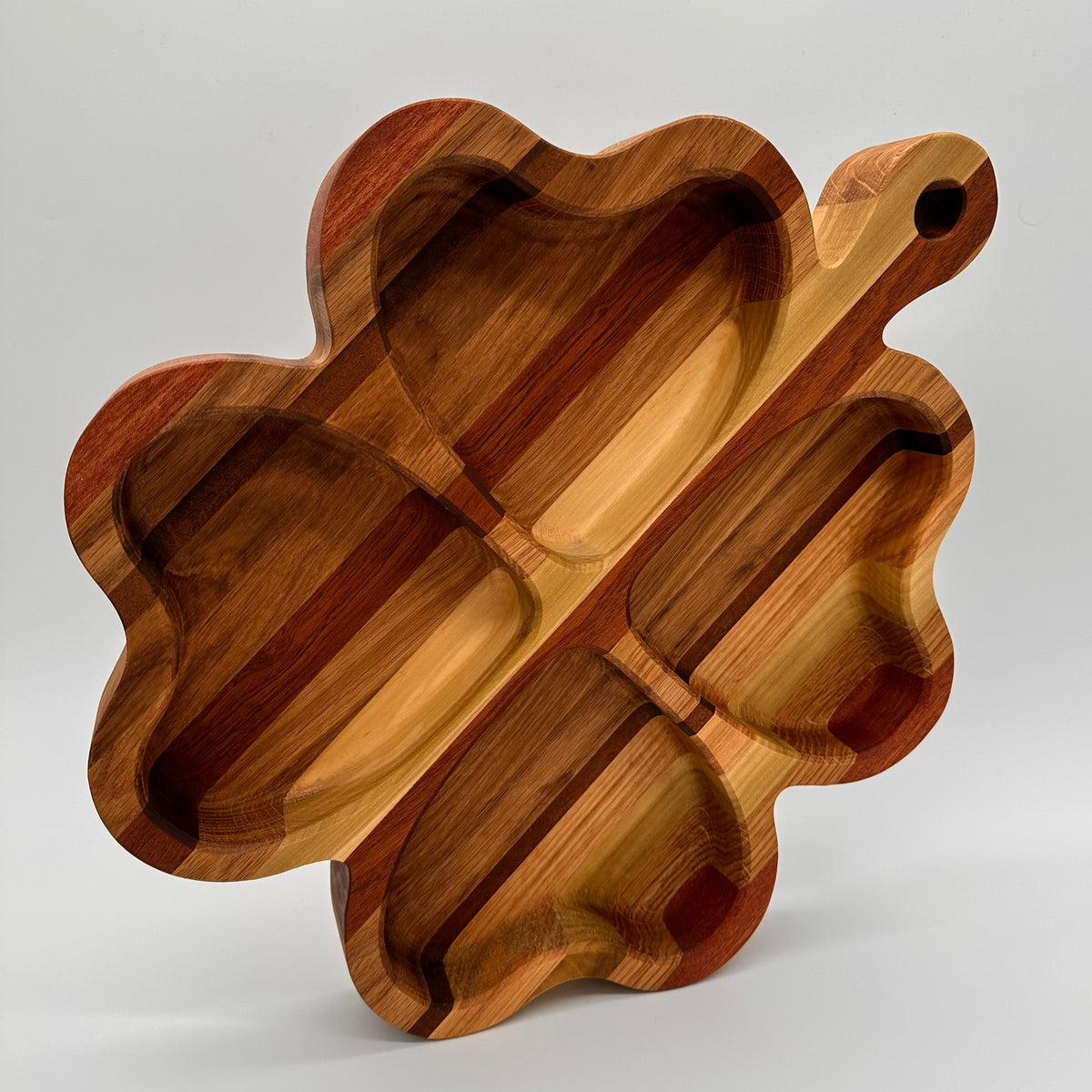 Wooden cutting board with wavy edges on a white background