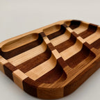 Wooden tray with geometric design on a light gray background