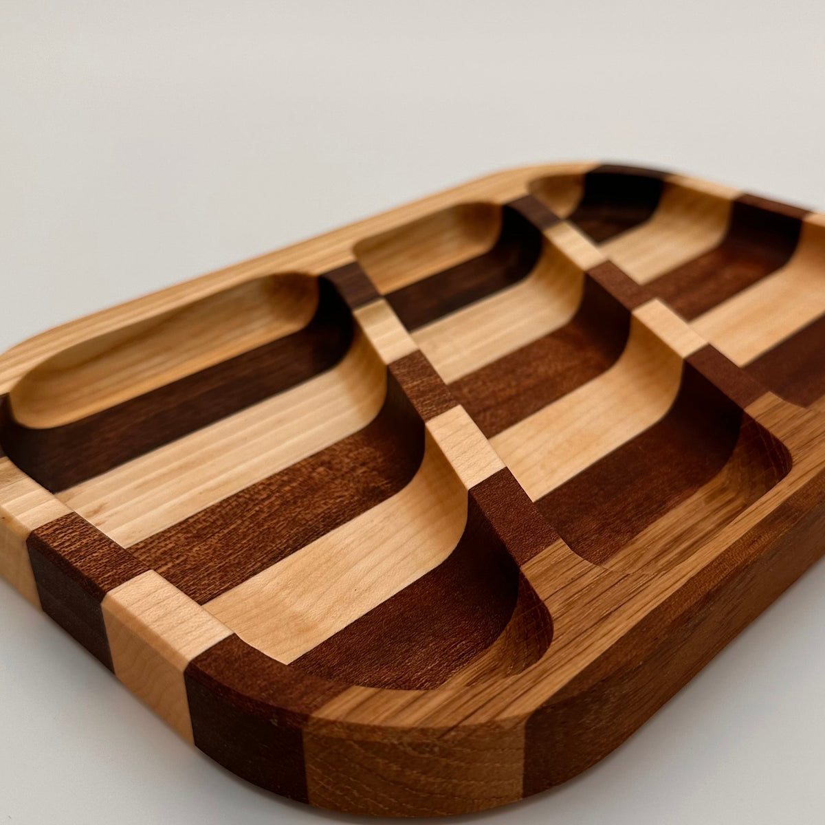 Wooden tray with geometric design on a light gray background