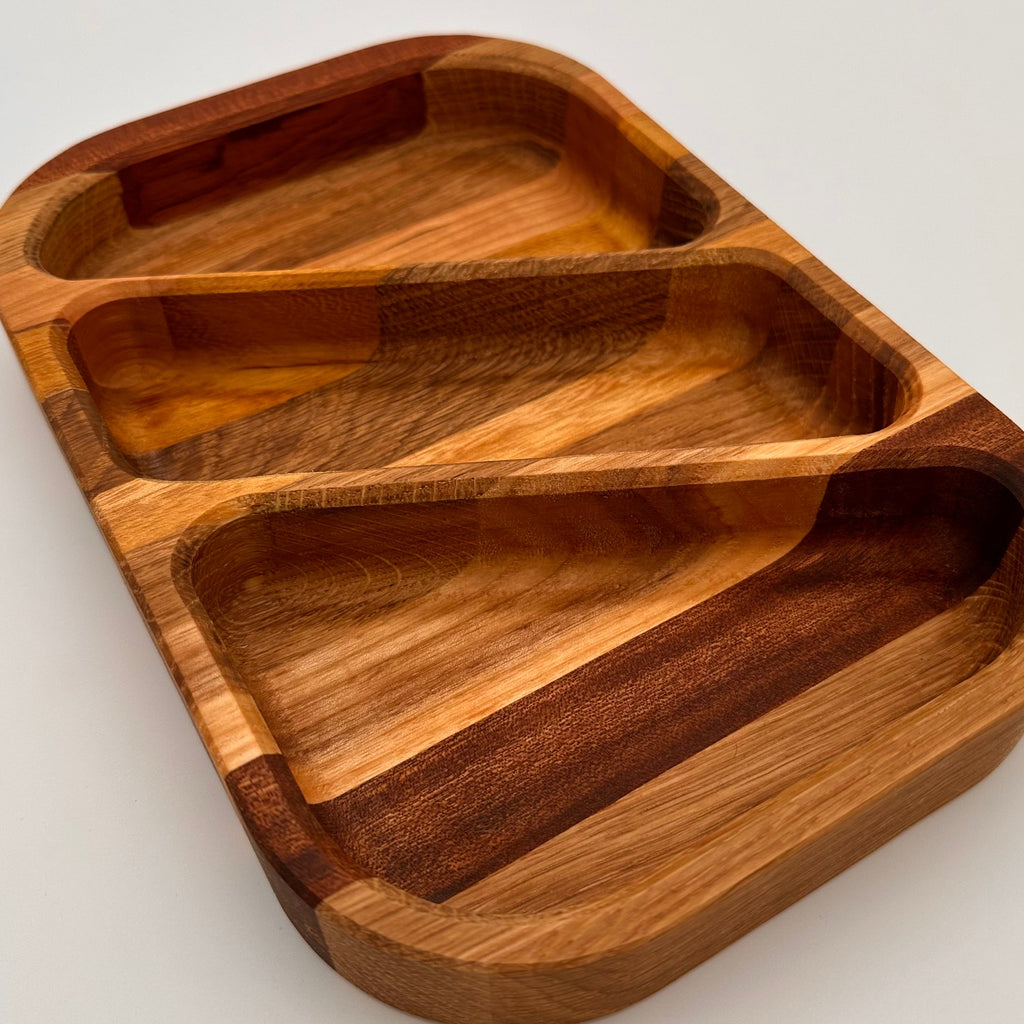 Wooden tray with divided sections on a light gray background
