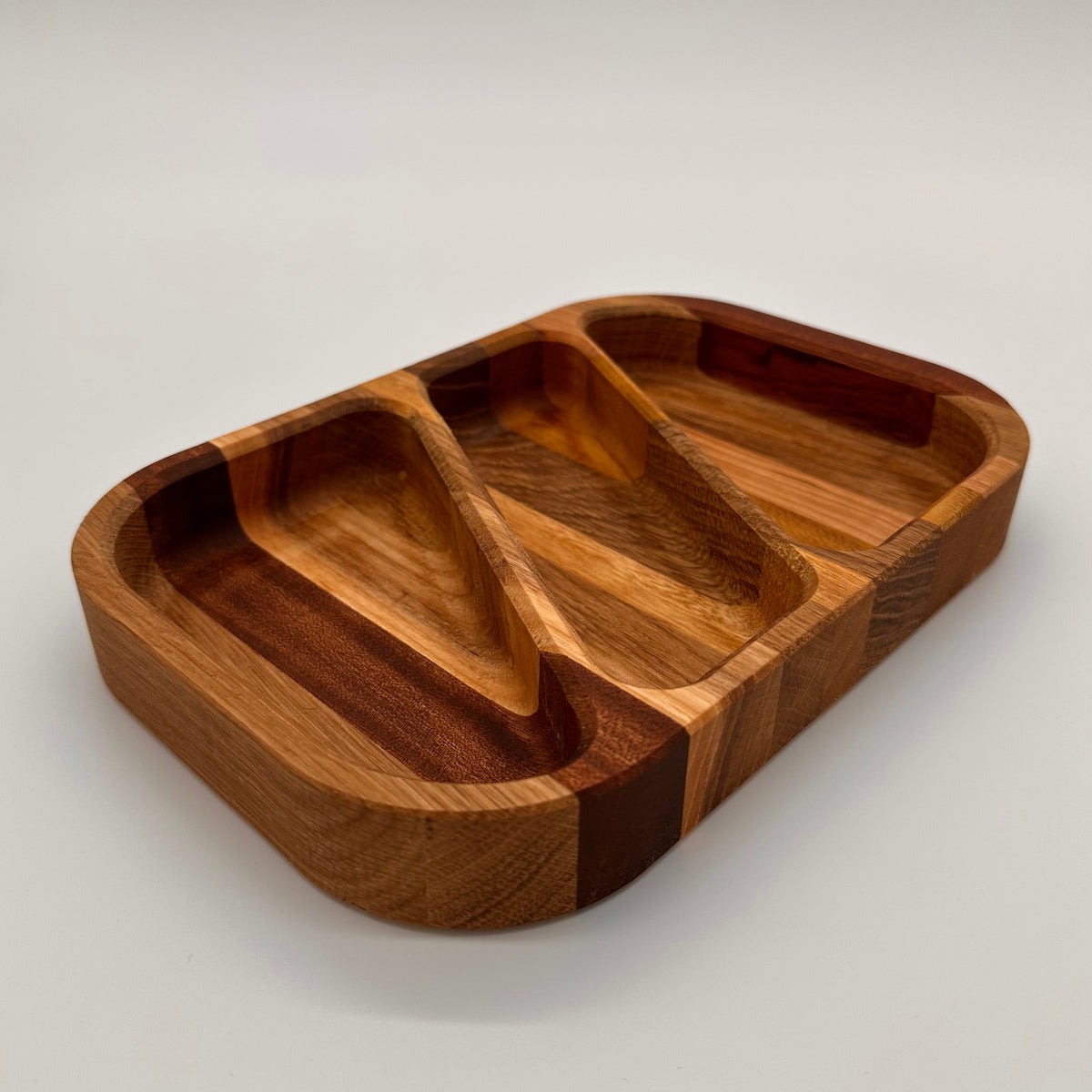 Wooden tray with compartments on a light gray background