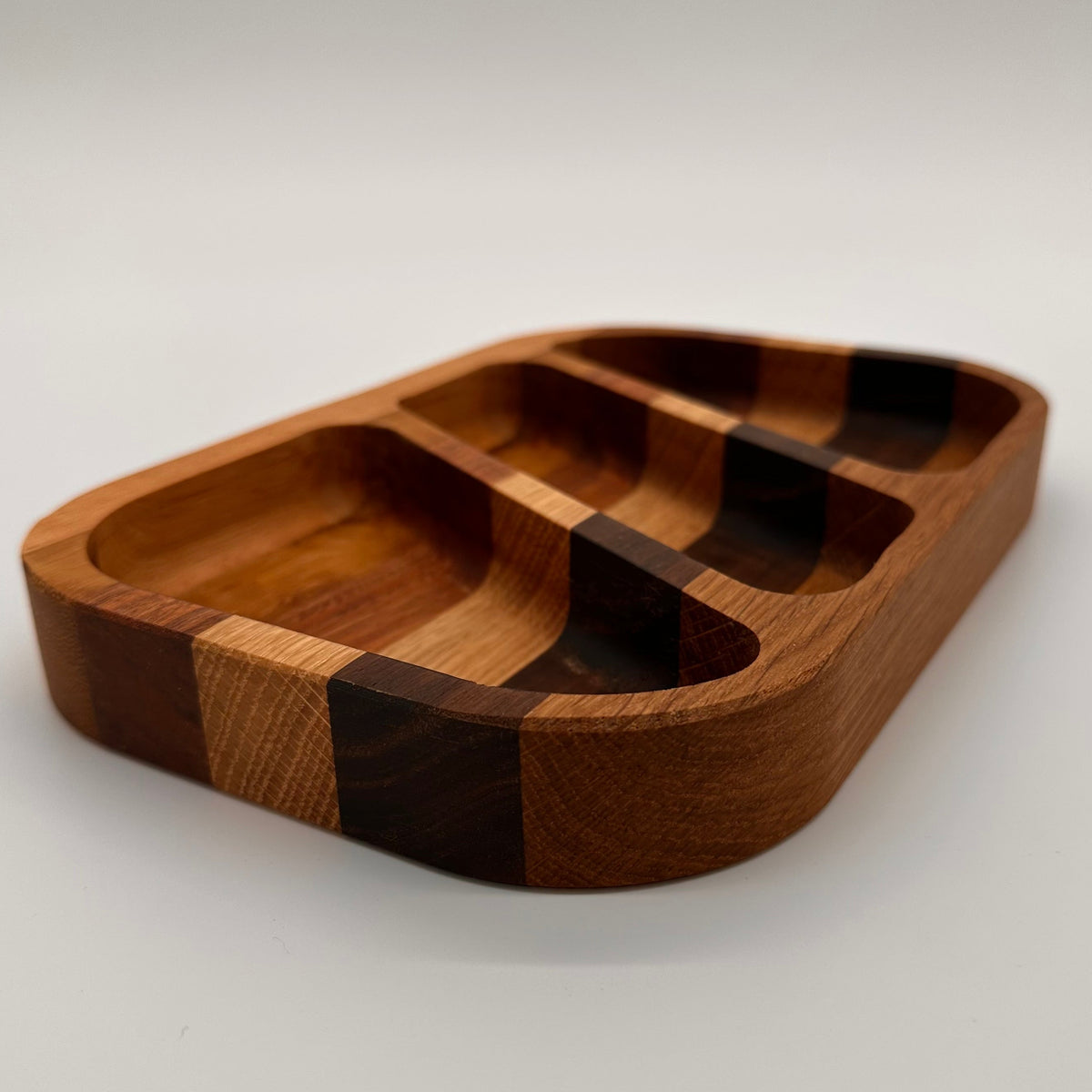 Wooden tray with compartments on a light gray background