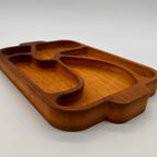 Wooden tray with divided sections on a white background
