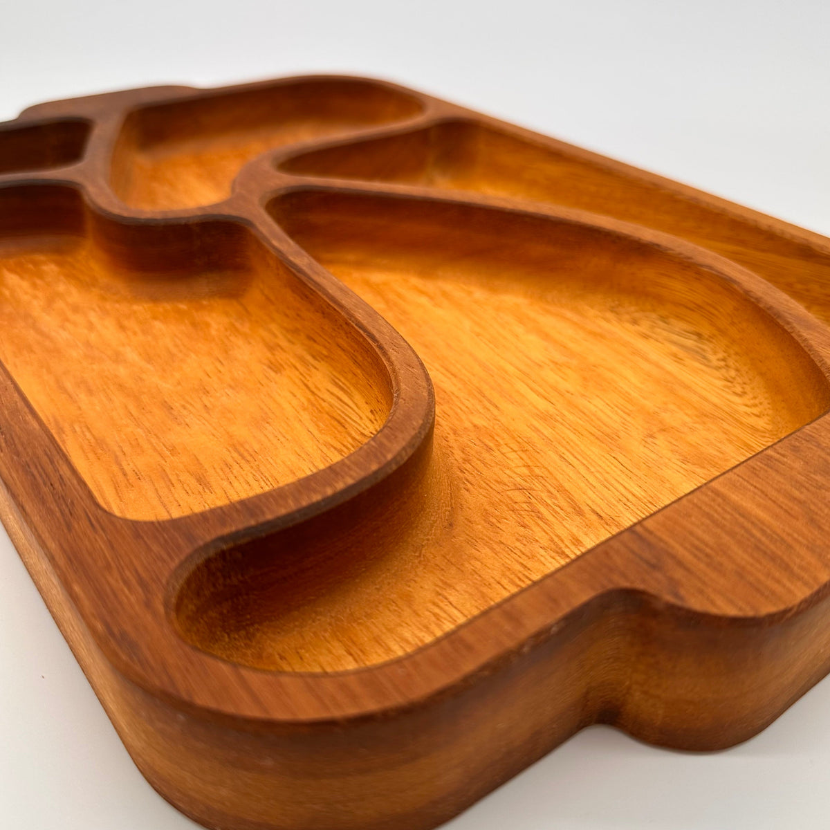 Wooden tray with a unique design on a white background