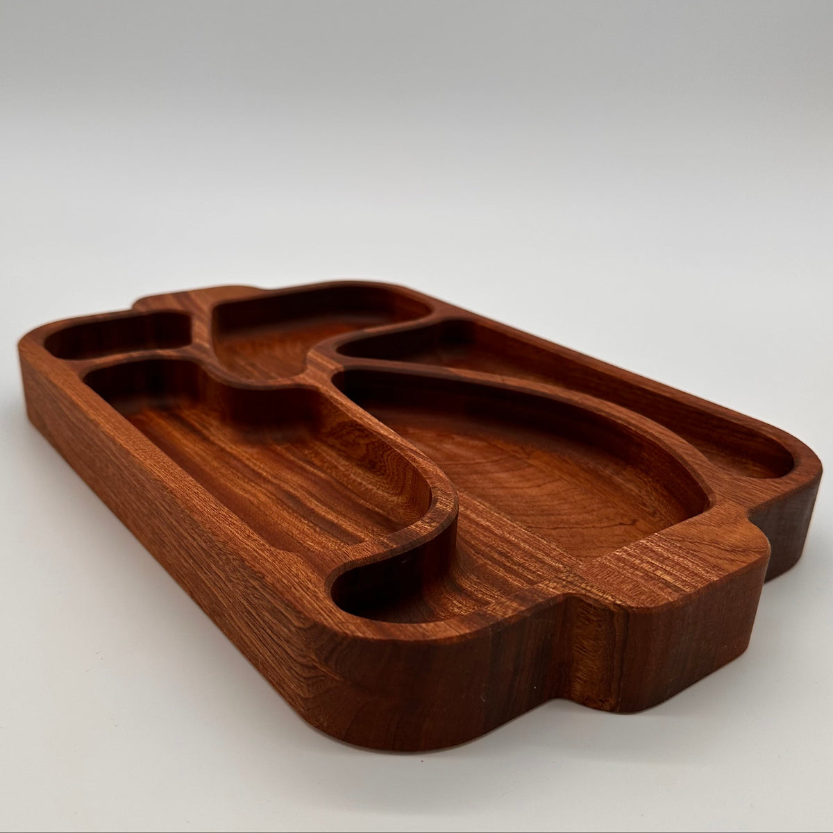 Wooden tray with unique design on a white background