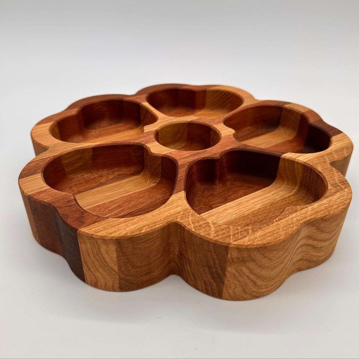 Wooden tray with multiple compartments on a white background