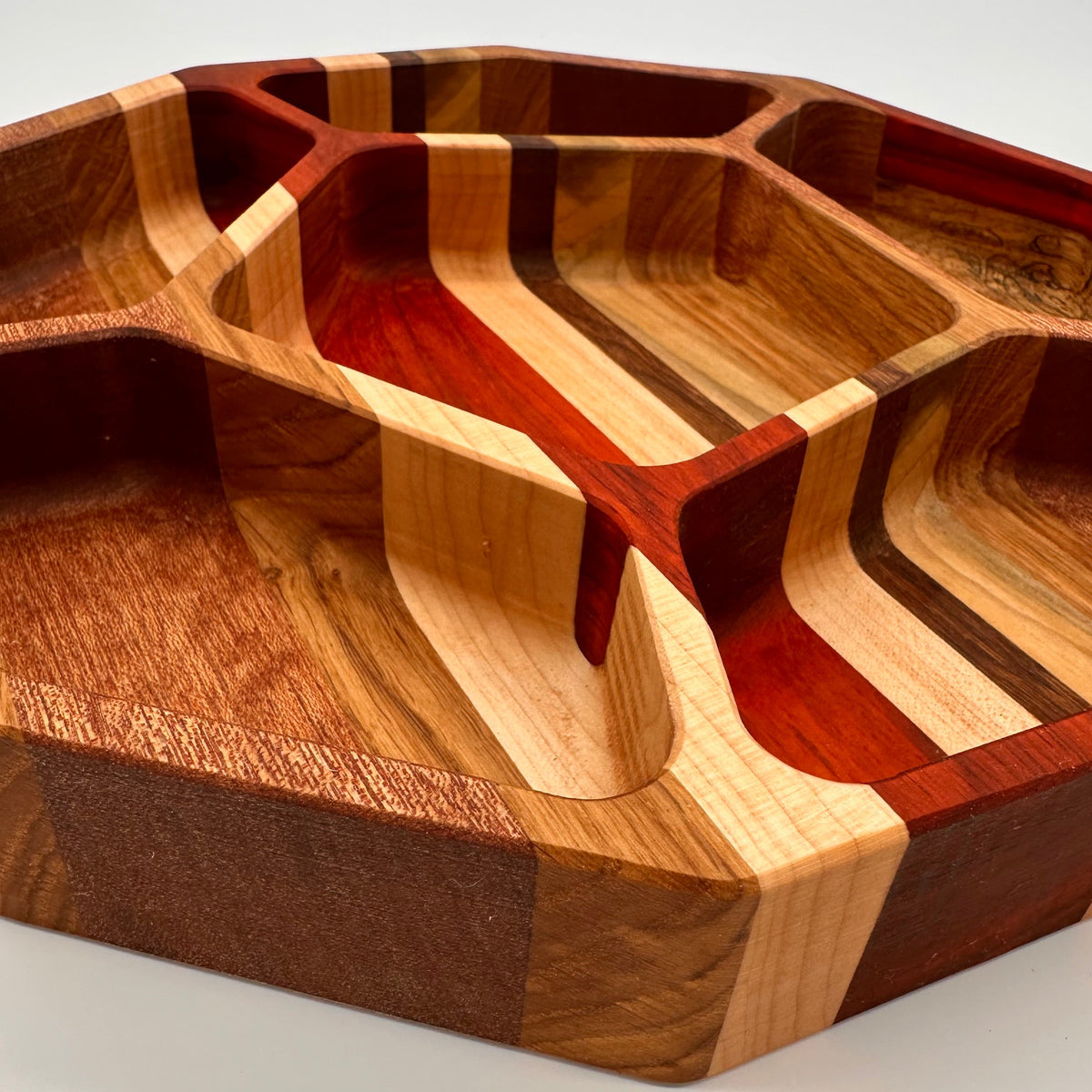 Wooden tray with wavy edge design on a white background