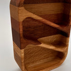 Wooden knife block with multiple slots on a white background
