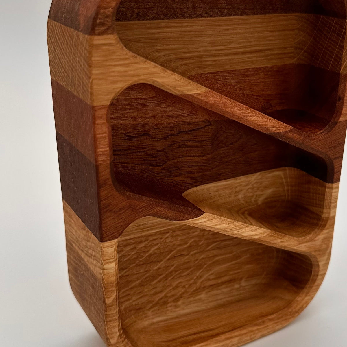 Wooden knife block with multiple slots on a white background