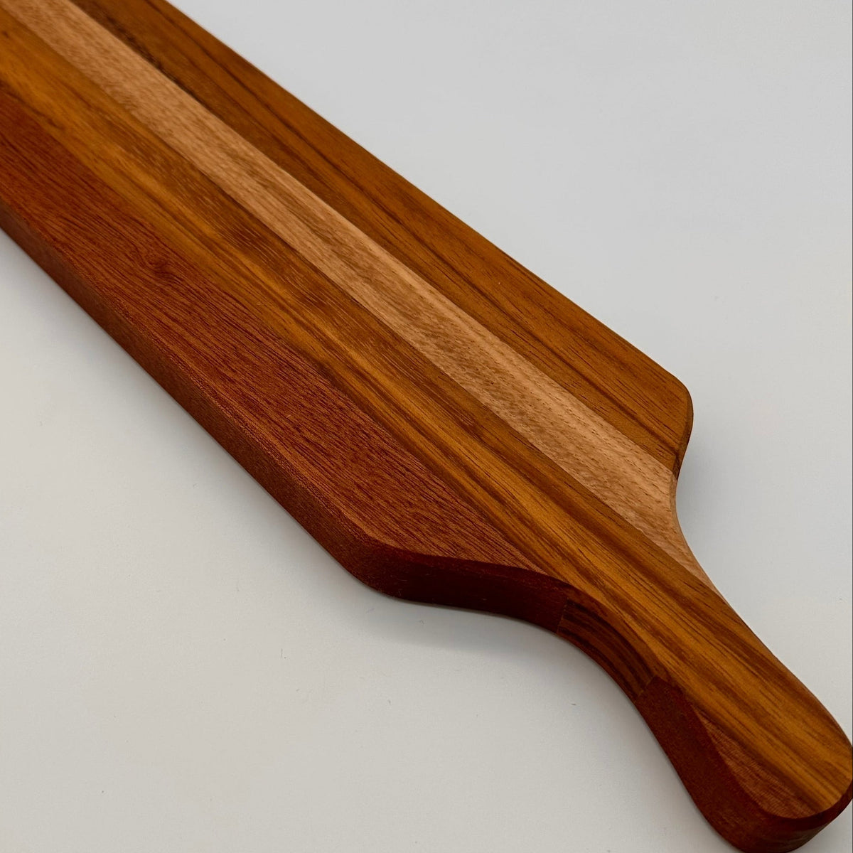 Wooden cutting board on a light gray background