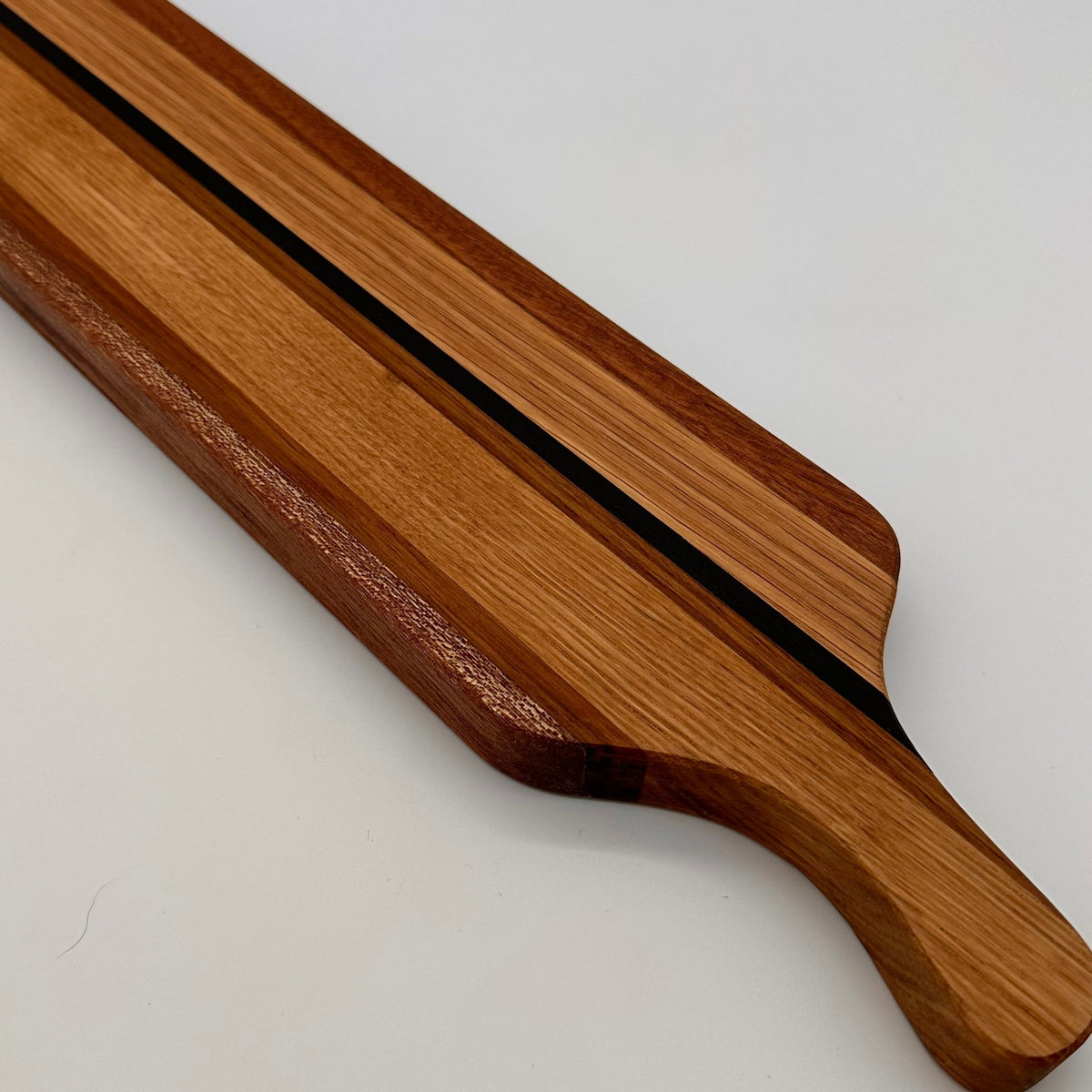 Wooden cutting board with a handle on a white background