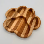 Wooden paw-shaped tray on a light gray background