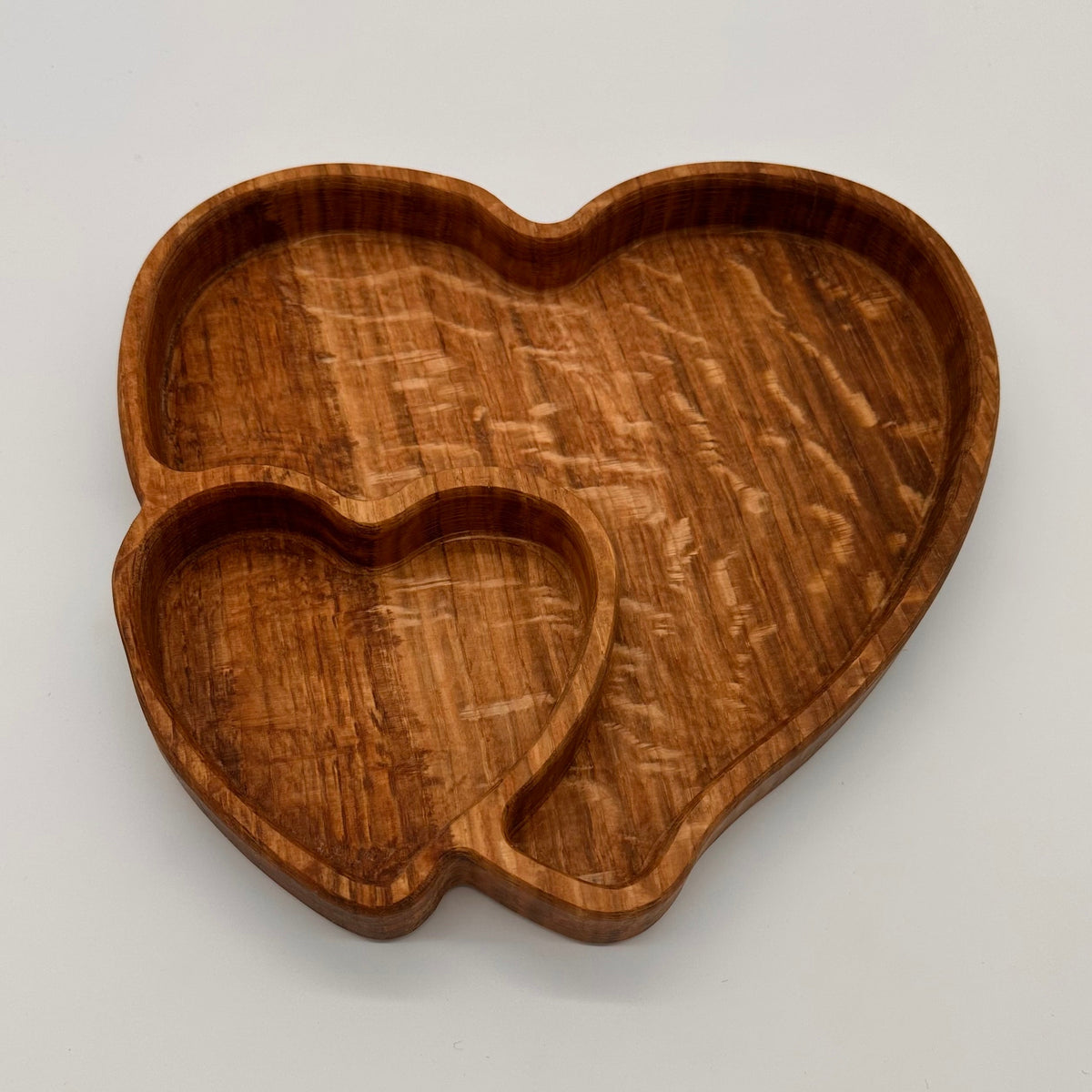 Wooden heart-shaped tray on a light gray background