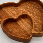Wooden heart-shaped tray on a light gray background