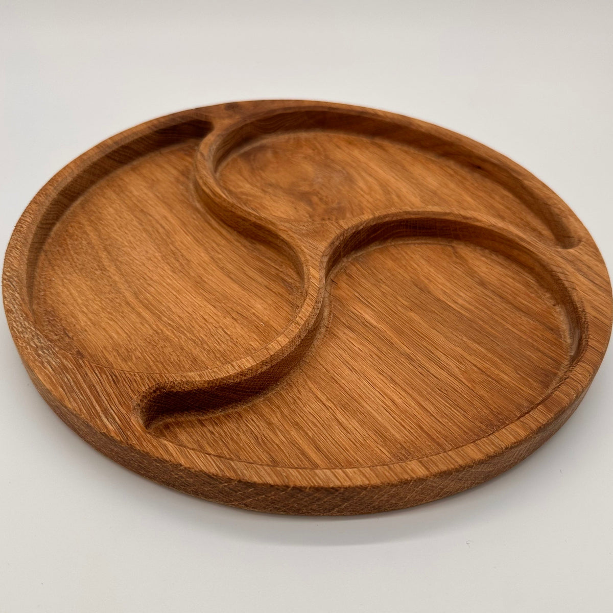 Wooden tray with divided sections on a white background