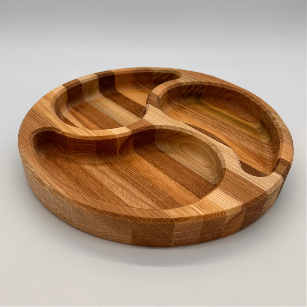 Wooden tray with divided sections on a light gray background