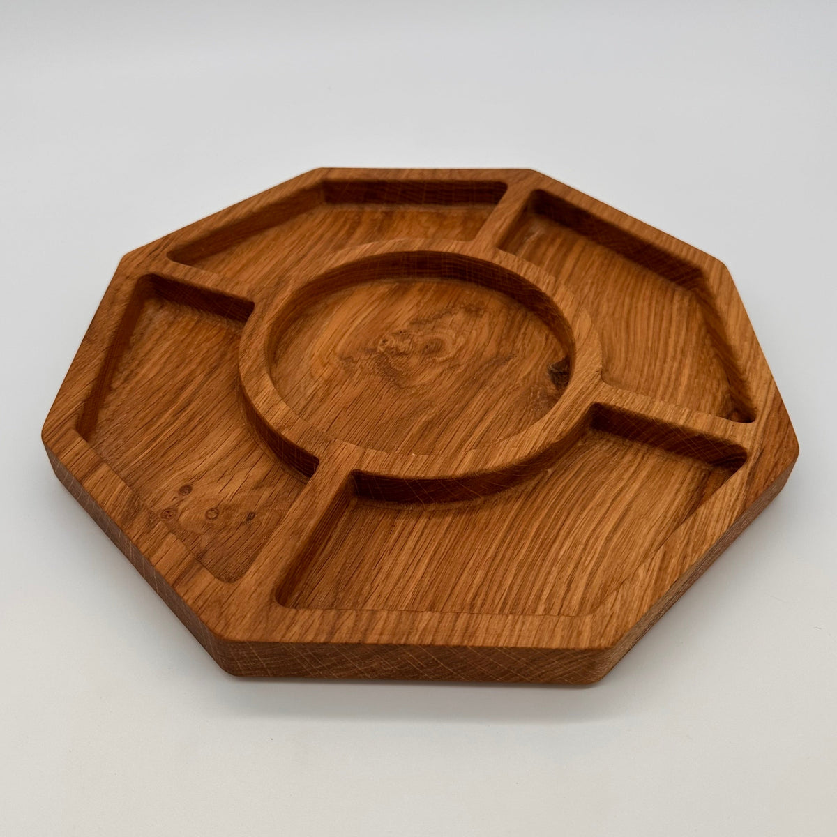 Wooden tray with divided sections on a light gray background