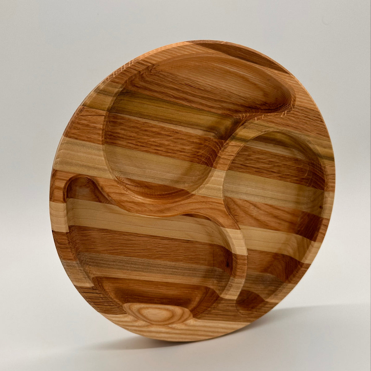 Wooden plate with a unique design on a light gray background