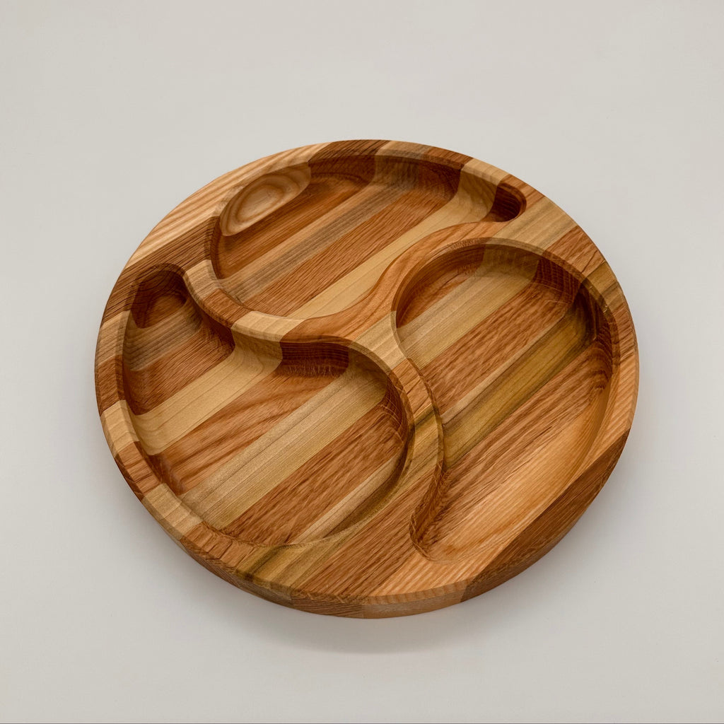 Wooden tray with divided sections on a light gray background