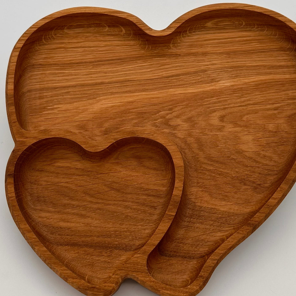 Wooden heart-shaped trays on a light gray background