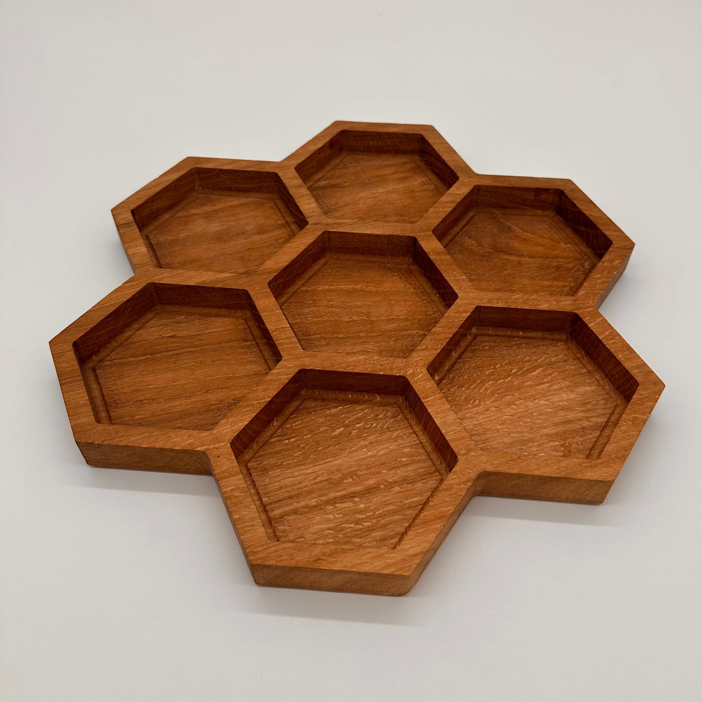 Wooden honeycomb tray on a light gray background