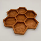 Wooden honeycomb tray on a light gray background