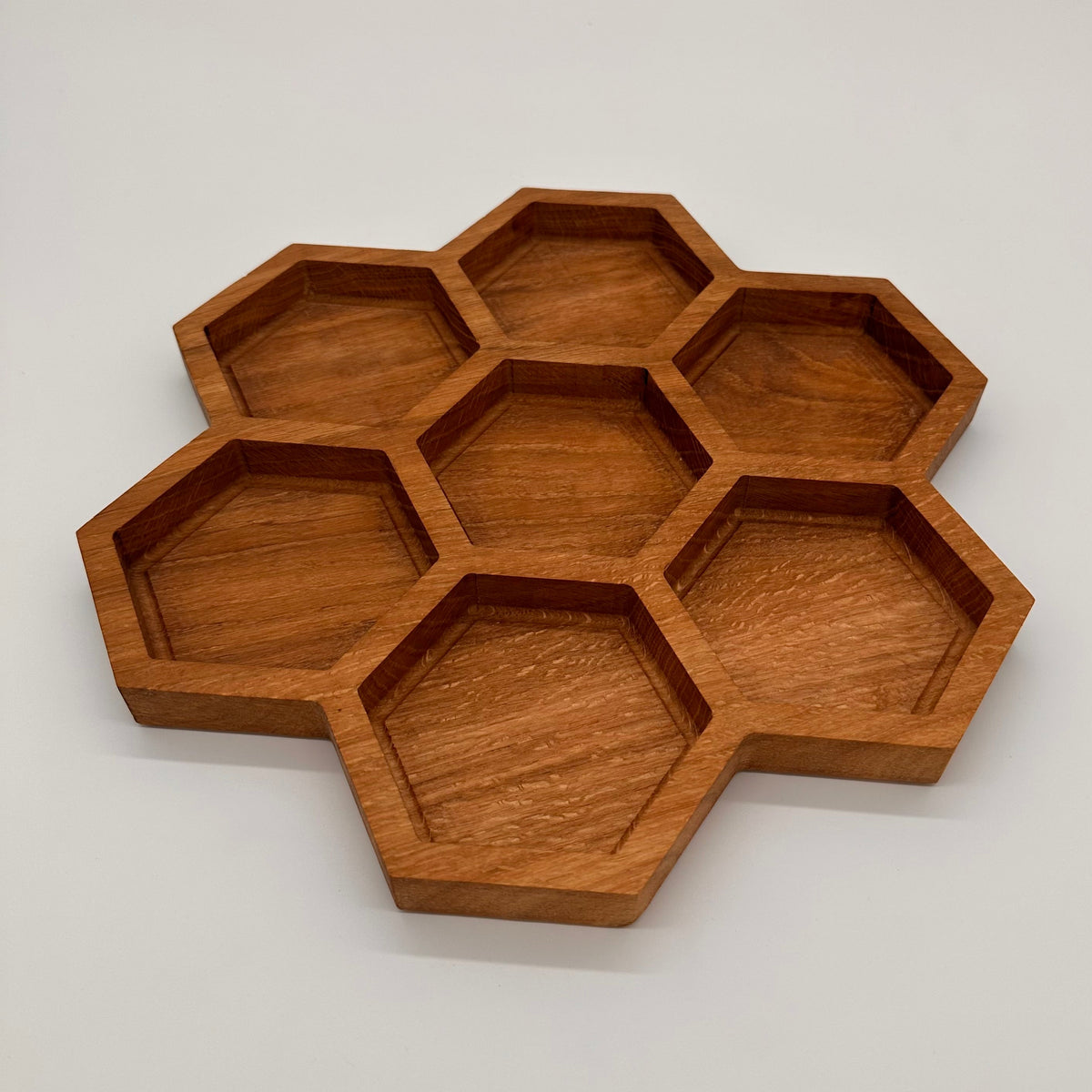 Wooden honeycomb tray on a light gray background