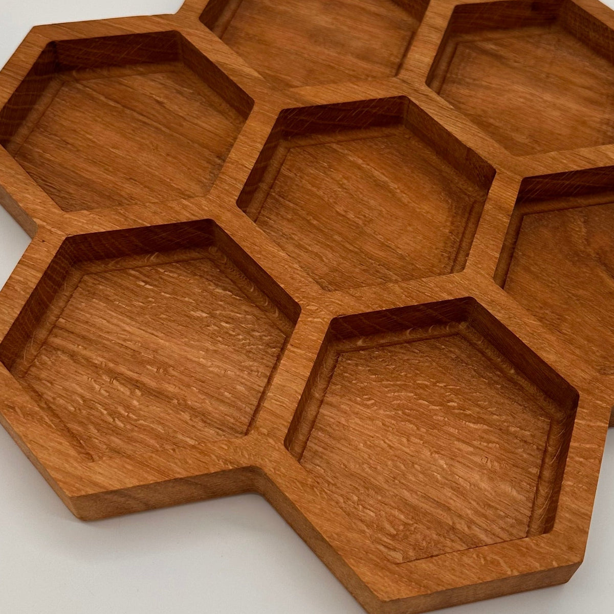 Wooden honeycomb tray on a light gray background