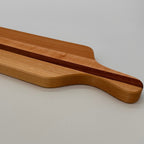 Wooden cutting board with a handle on a light gray background