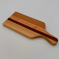 Wooden cutting board with a dark stripe on a light gray background