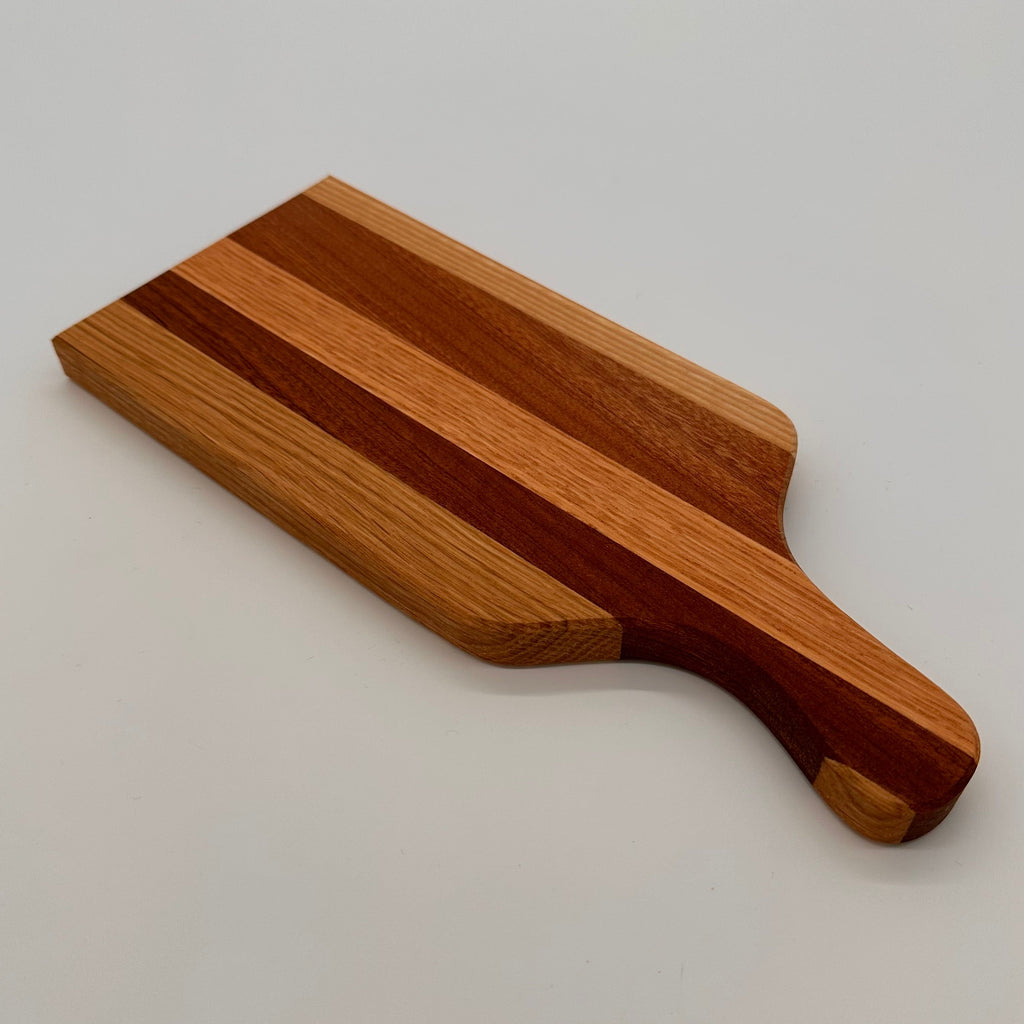 Wooden cutting board with a handle on a light gray background