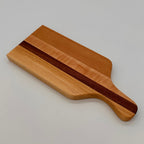 Wooden cutting board with a dark stripe on a light gray background