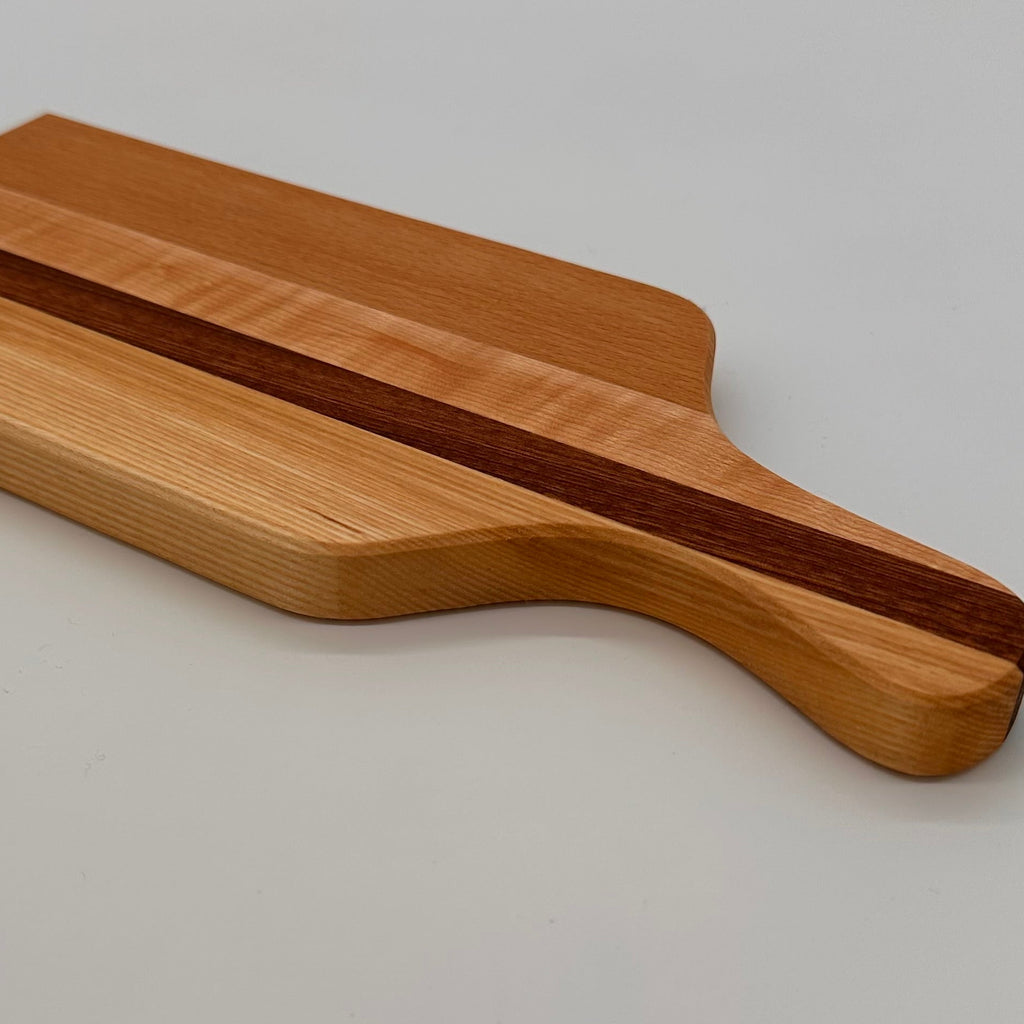 Wooden cutting board with a dark stripe on a light gray background