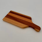 Wooden cutting board with a handle on a light gray background