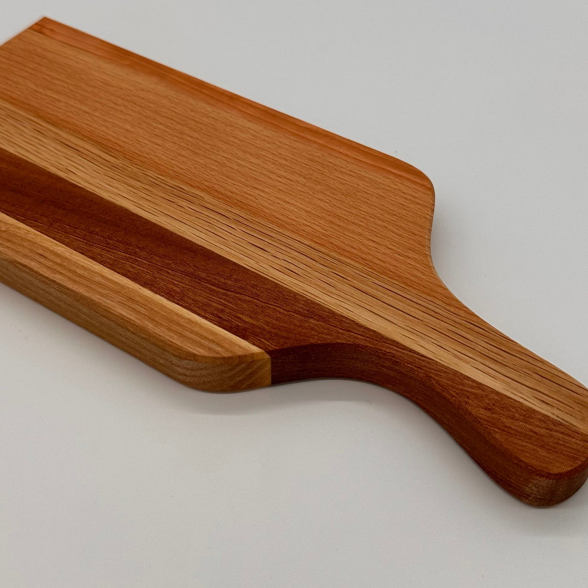 Wooden cutting board on a light gray background