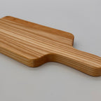 Wooden paddle on a light gray background