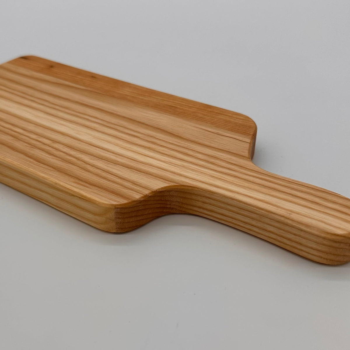 Wooden paddle on a light gray background