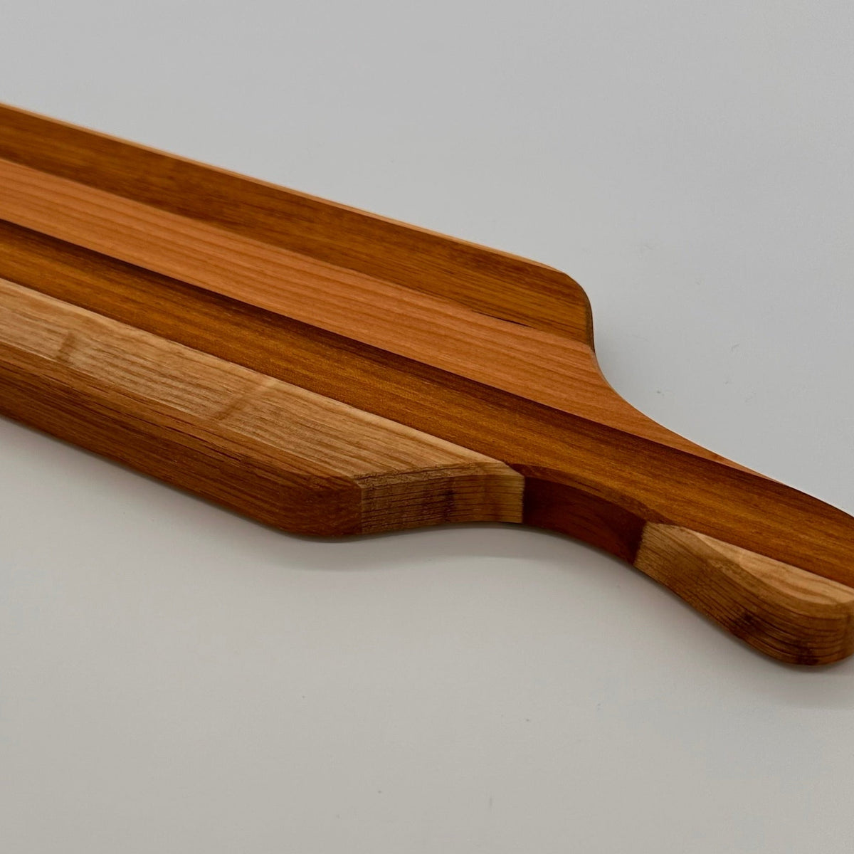 Wooden cutting board on a light gray background