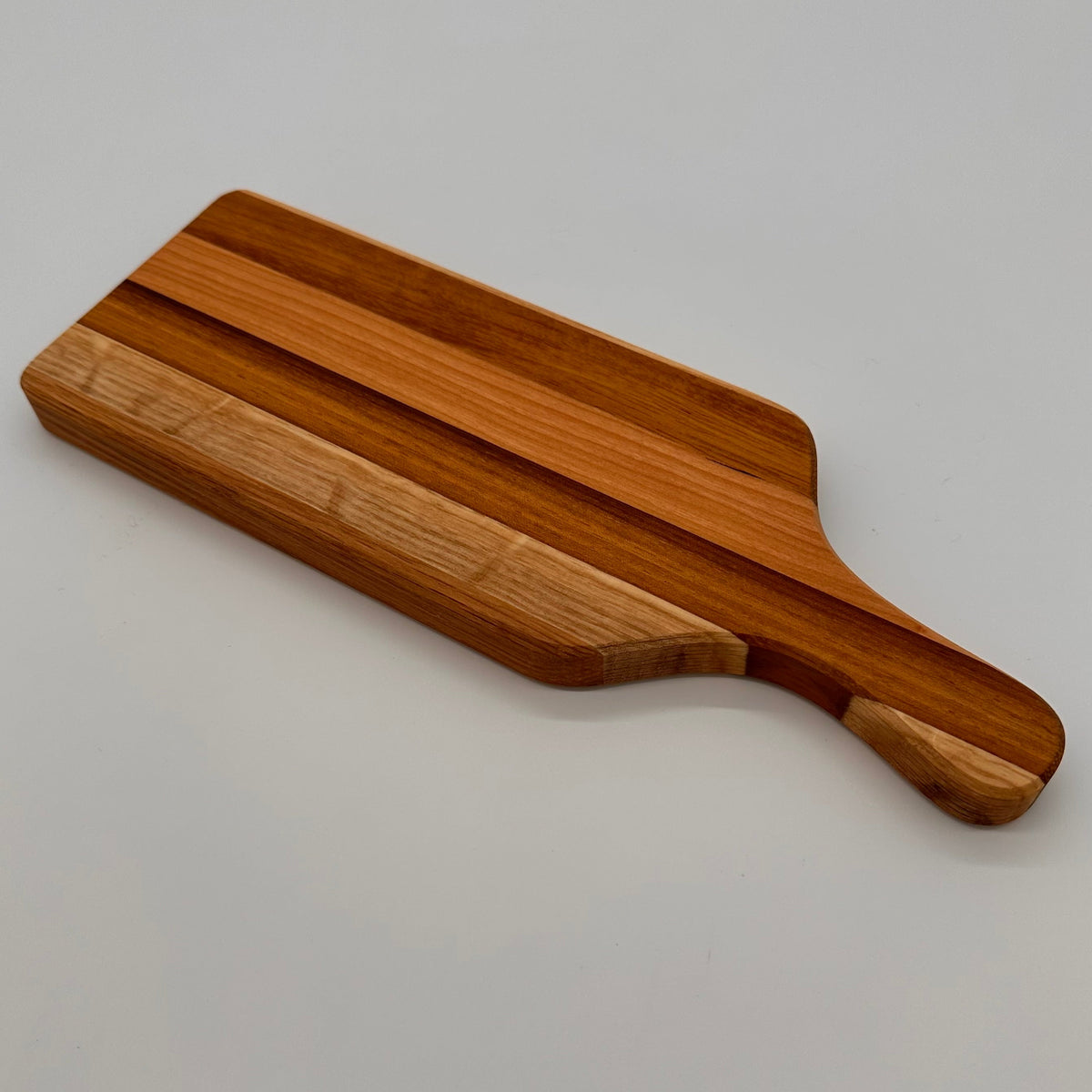 Wooden cutting board on a light gray background