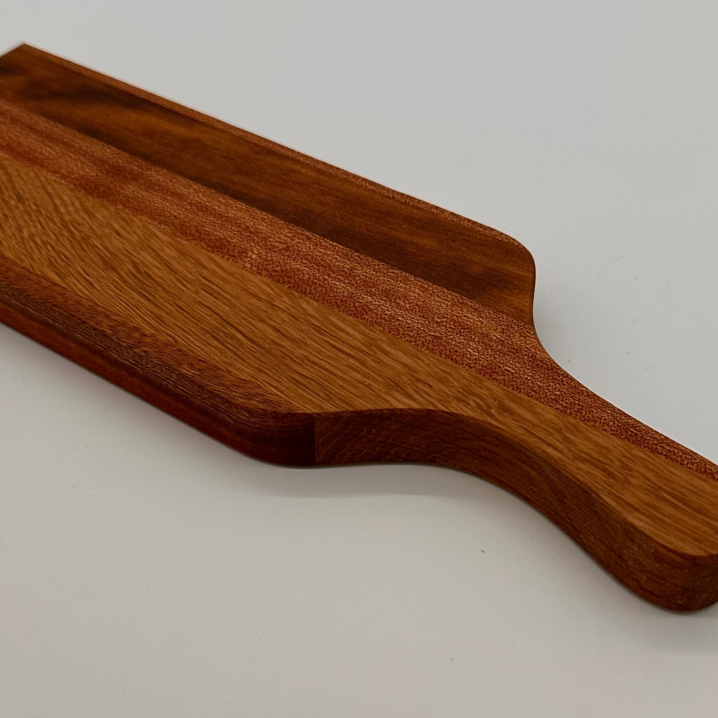 Wooden paddle on a light gray background