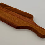 Wooden paddle on a light gray background