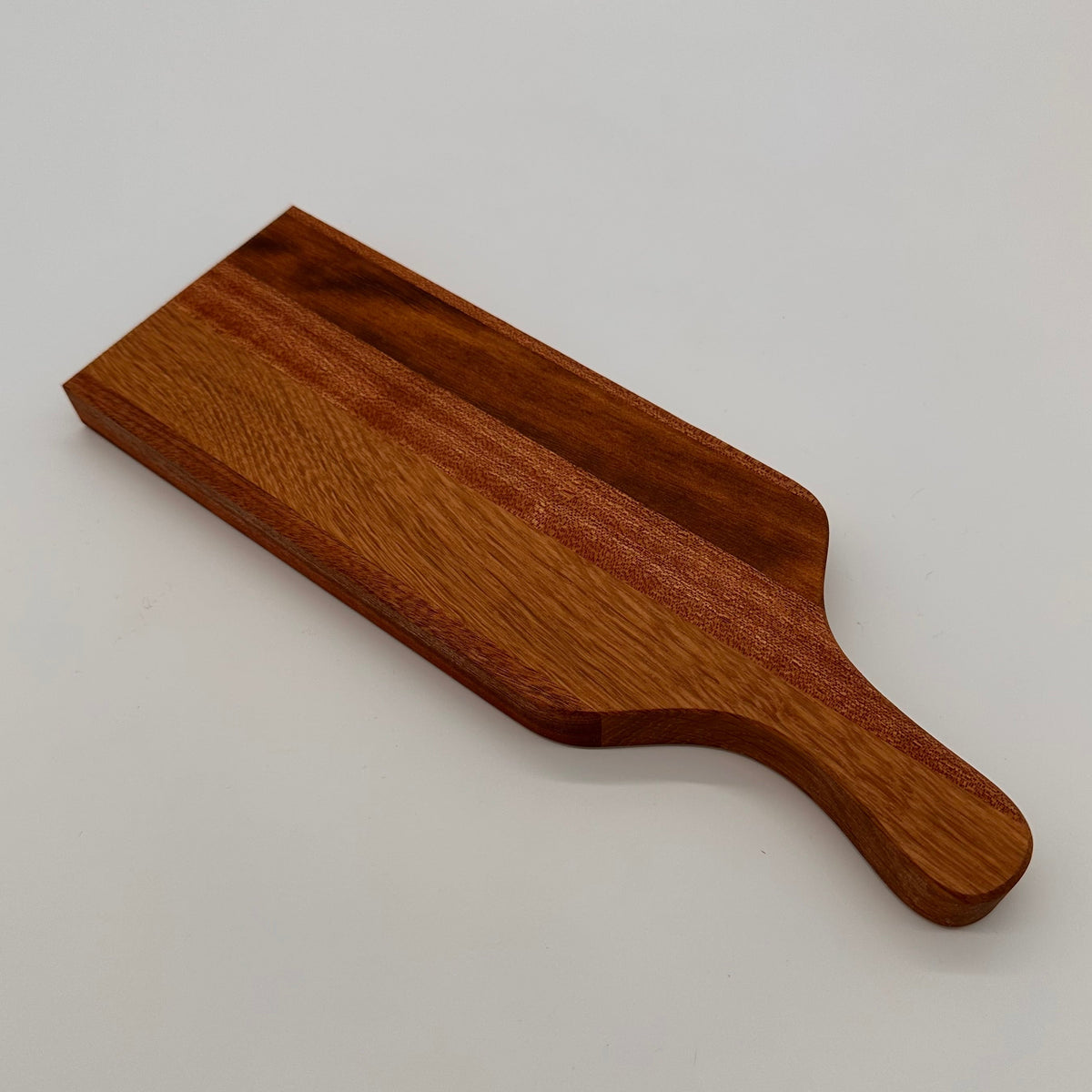 Wooden cutting board on a light gray background