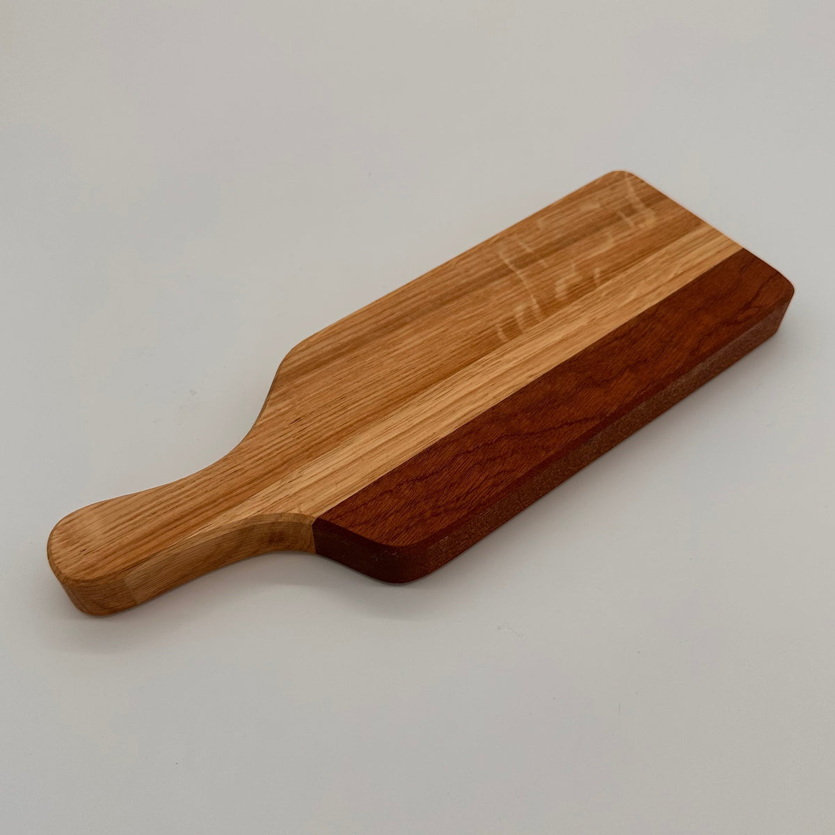 Wooden paddle on a light gray background