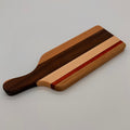 Wooden cutting board with a handle on a gray background
