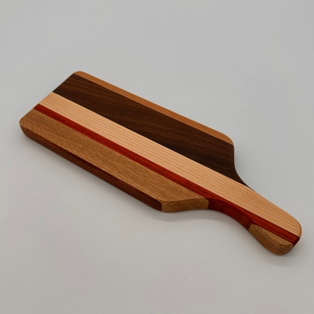 Wooden cutting board with a handle on a light gray background